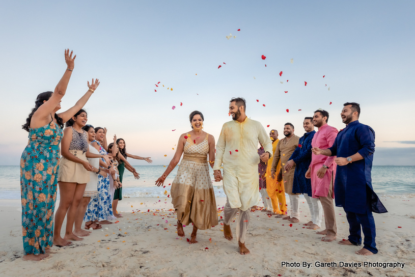 Bride and groon walking on beach capture