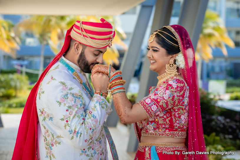 Indian groom kissing on Inndian Bride's Hand