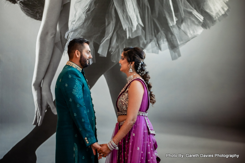 Indian wedding couple looking each other with love