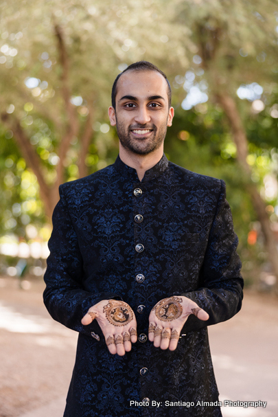Indian Groom showcasing mehandi design on his hand