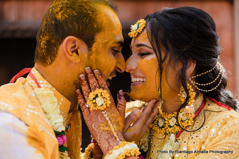indian couple applying haldi to each other