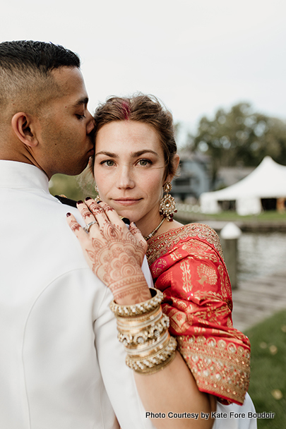 Indian groom showing his love by kissing her