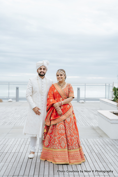 Indian wedding couple happily posing for outdoor photoshoot