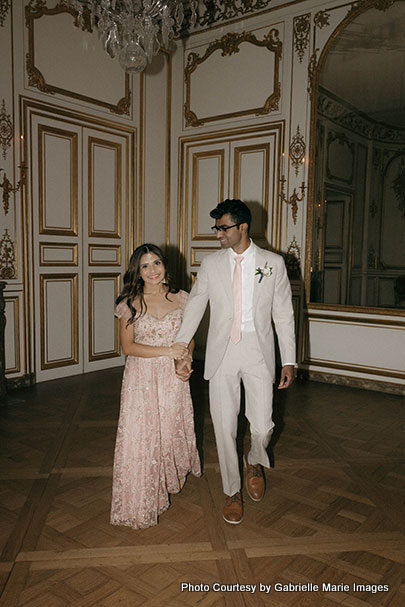 Holding hands Indian bride and groom