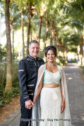 Candid moment of laughter between bride and groom at a beach wedding Candid moment of laughter between bride and groom at a beach wedding