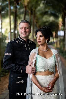 Ekta and Dan posing during their outdoor photoshoot at a beach resort in Florida