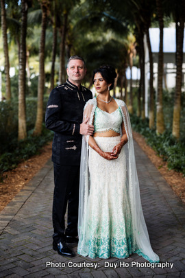 Bride and groom enjoying an outdoor photoshoot with ocean views and tropical surroundings Bride and groom enjoying an outdoor photoshoot with ocean views and tropical surroundings