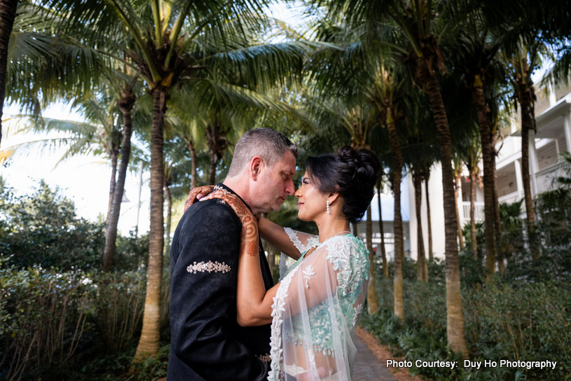 Couple sharing smiles during their scenic outdoor wedding photoshoot Couple sharing smiles during their scenic outdoor wedding photoshoot