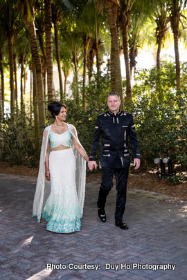 Romantic outdoor photoshoot of the newlyweds with soft natural lighting and ocean breeze.