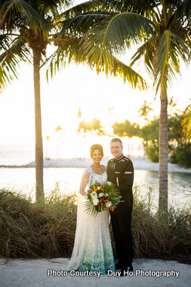 Soft, warm lighting accentuating the couple’s expressions during their beachside shoot Soft, warm lighting accentuating the couple’s expressions during their beachside shoot