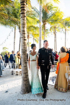 Wedding ceremony setup with floral decorations and ocean views in the background