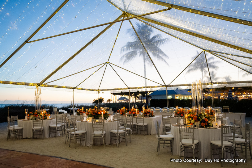Wedding ceremony setup with floral decorations and ocean views in the background Wedding ceremony setup with floral decorations and ocean views in the background