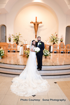 indian wedding couple posing at church