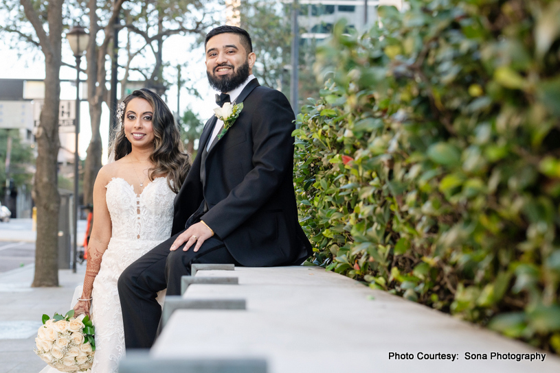 Ashley and Justin sharing a quiet moment outdoors surrounded by lush greenery