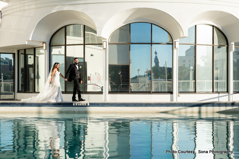 Bride and groom exchanging smiles as soft sunlight bathes the scene