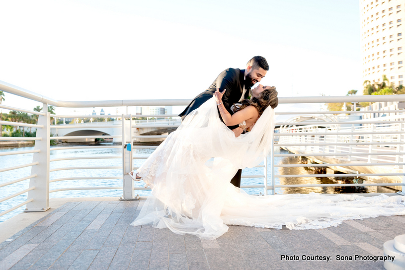 Close-up of the couple’s hands entwined, with natural scenery framing the shot Close-up of the couple’s hands entwined, with natural scenery framing the shot