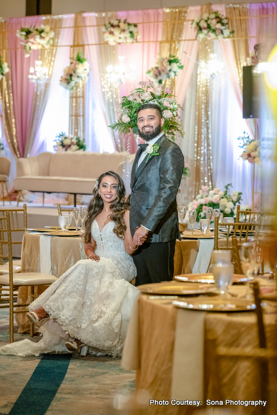 Indian wedding couple at decorated dinning hall