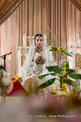 A portrait of the bride dressed in traditional attire with a long veil, radiating grace and joy. A portrait of the bride dressed in traditional attire with a long veil, radiating grace and joy.