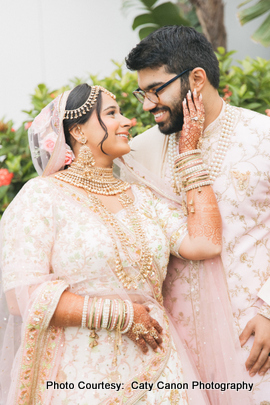 Ami and Vinny in traditional Indian wedding outfits embracing each other