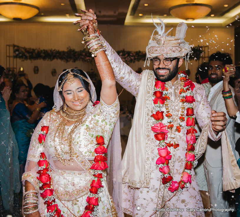 Ami and Vinny walking together in pastel traditional wedding attire Ami and Vinny walking together in pastel traditional wedding attire