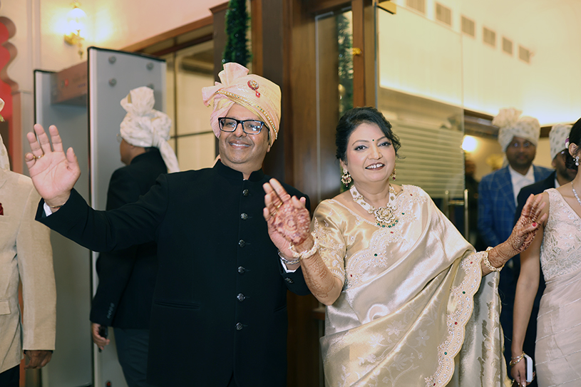 Radhika Agarwal and Krishan Garg posing together in traditional attire during their silver anniversary celebration