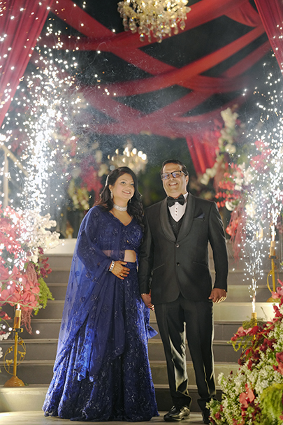 Portrait of Radhika and Krishnan smiling together during their 25th wedding anniversary destination celebration
