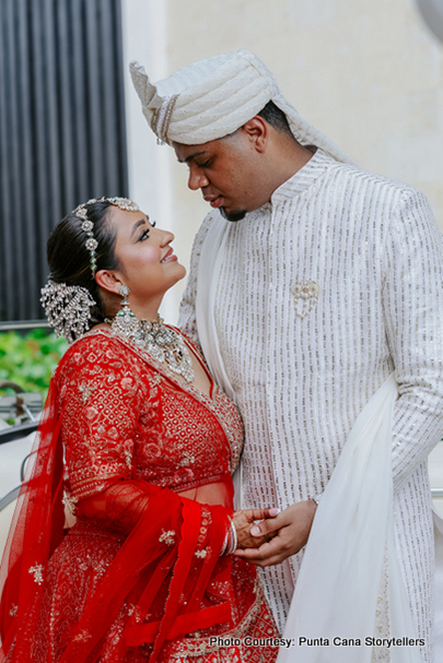 Indian bride wearing mang tika and groom wearing turban