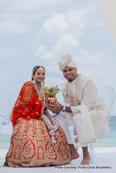 Indian bride and groom holding kumbh in their hand